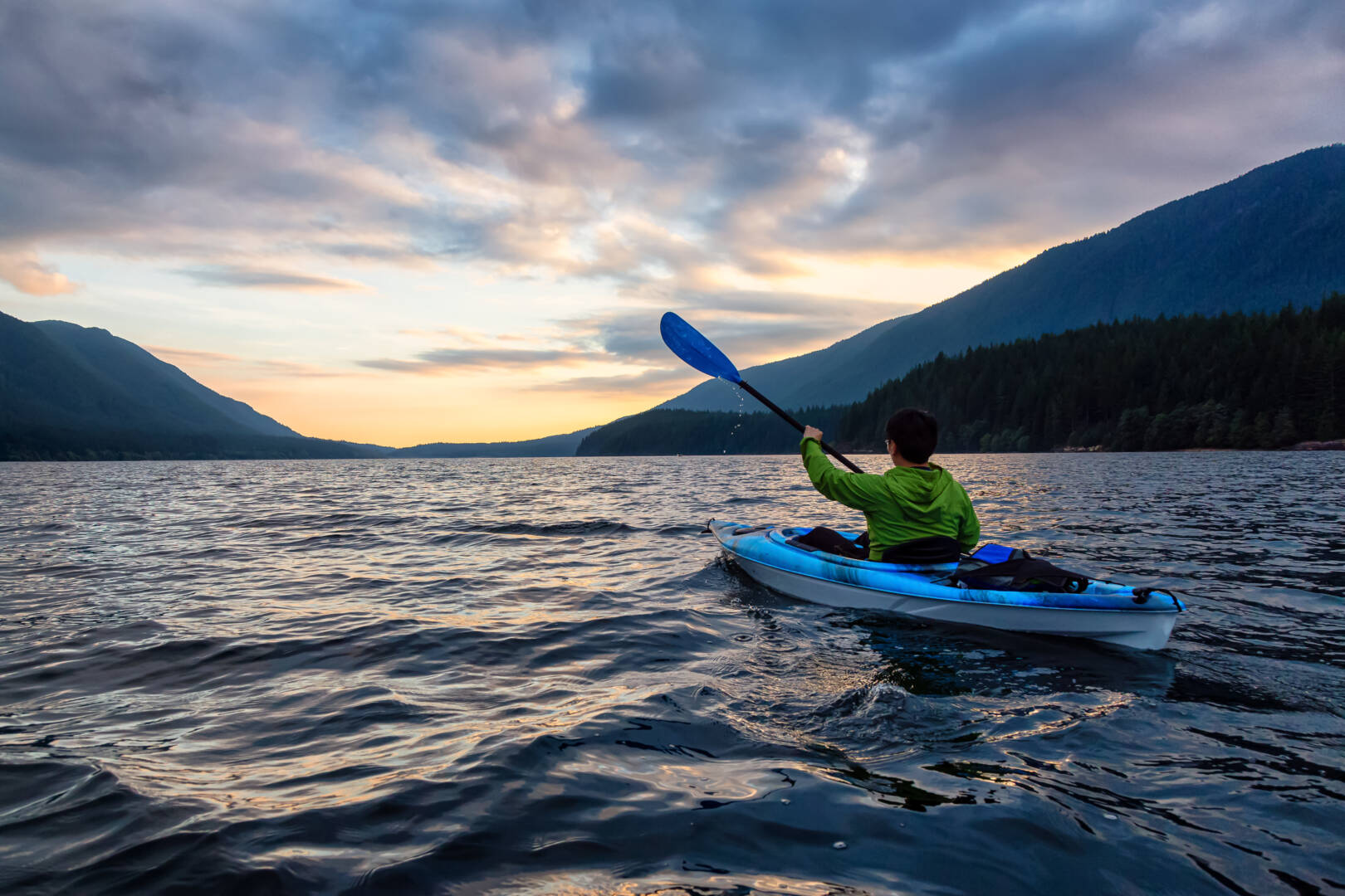 View of Person Kayaking on Scenic Lake at Sunset